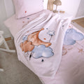 babybest Kuscheldecke ‘Moon and Stars’ auf einem Bett mit zartrosa Bettwäsche