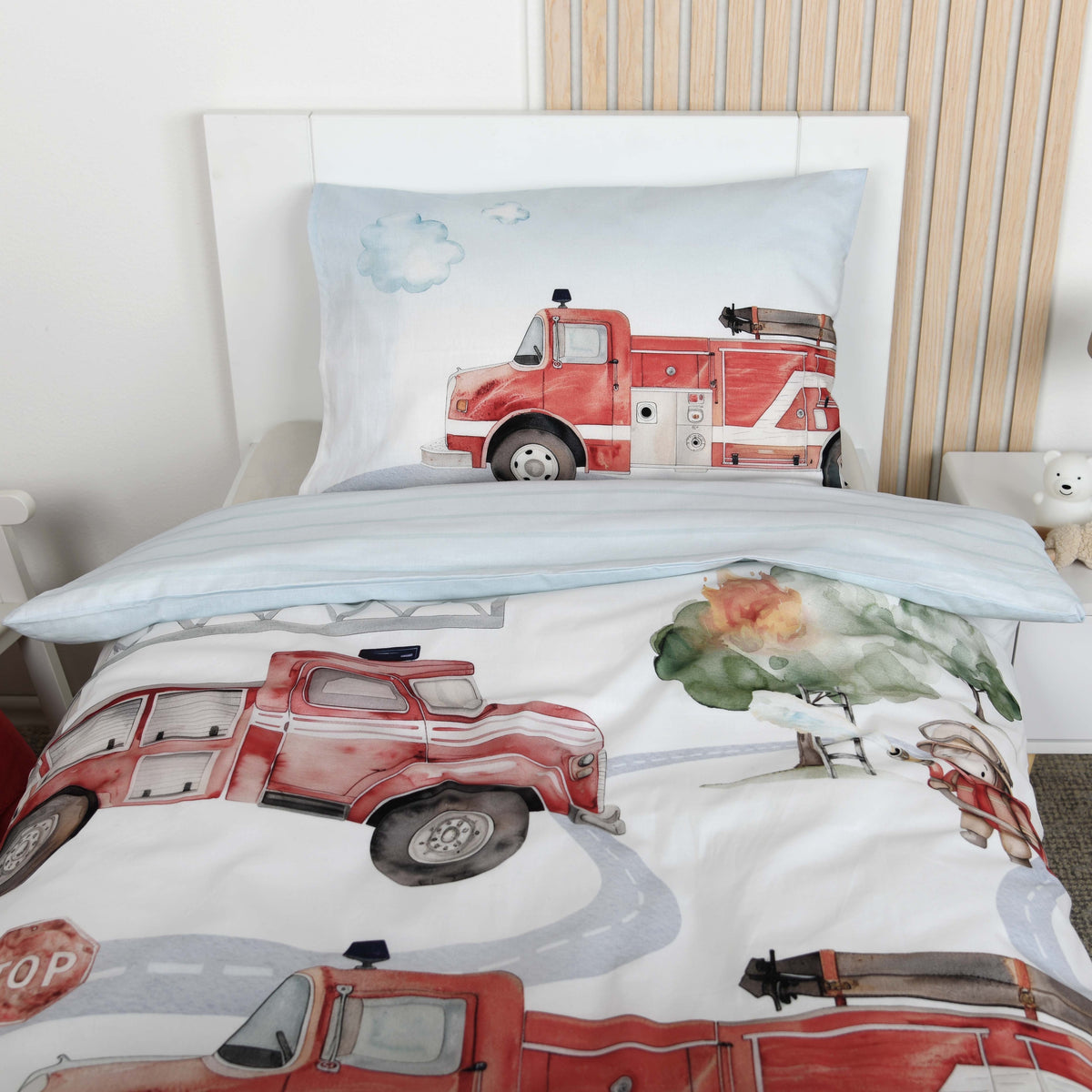 Kopfende mit Kissenbezug ‘Feuerwehr’ 40 x 60 cm und umgeschlagenem Bettbezug mit hellblau gestreifter Wendeseite