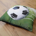 Dekokissen ‘Fußball’ schräg auf Holzboden liegend