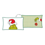 Grinch Kuschelkissen ‘Merry Grinchmas’ 30 x 50 cm: Vorderseite Grinch-Gesicht mit Weihnachtsmütze, Rückseite grün-weißes Karo mit Grinch-Hand und Christbaumkugel