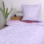 Bett mit der fliederfarbenen Marmor-Wendeseite und passendem Kissen