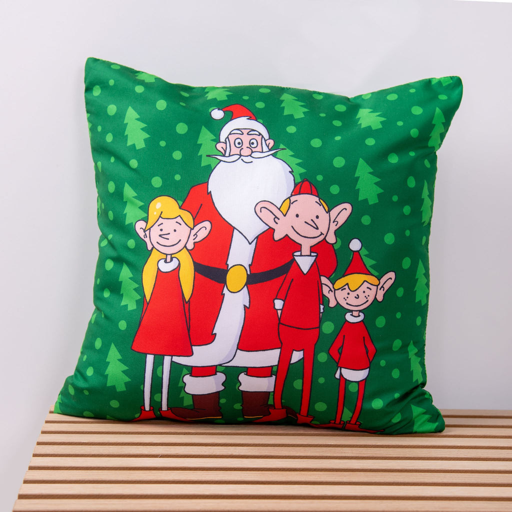 Grünes Kissen ‘Nordpol-Helden’ mit dem Weihnachtsmann und drei Elfen vor kleinen Tannen