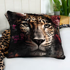 Wild Flowers Dekokissen ‘Leopard’ auf einem Bett mit weißem Laken, daneben eine Decke mit Leoprint